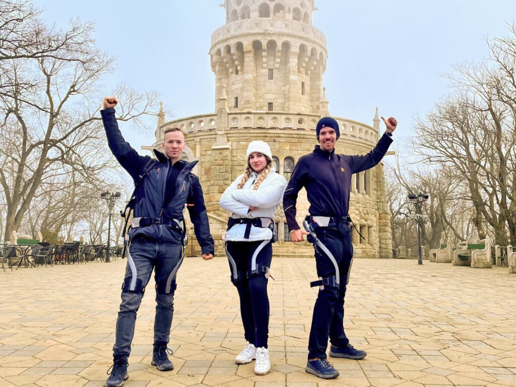 Three people wearing Hypershell exoskeletons during a tour to Elizabeth-lookout (Erzsébet kilátó) in Budapest, Hungary